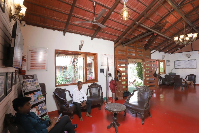 Individuals seated in the naturally lit reception lounge at Tapasya Health & Wellness