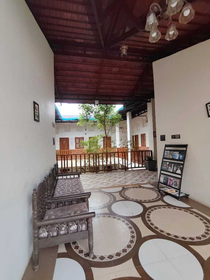 Open-air tiled verandah corridor outside patient rooms at Tapasya Health & Wellness retreat