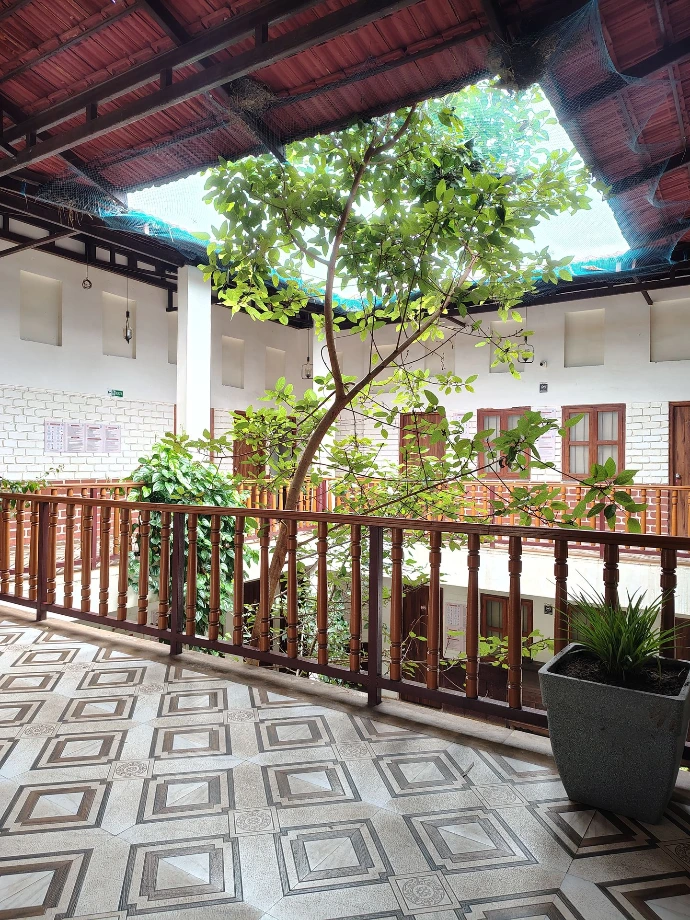 Garden-view accommodation balcony surrounded by greenery at Tapasya Health & Wellness