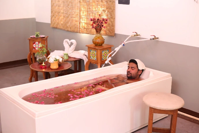Relaxing herbal rose-petal hydrotherapy bath treatment room at Tapasya Health & Wellness