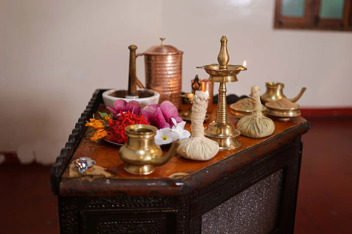 Panchakarma therapy tools, herbal boluses and brass vessels arranged at Tapasya Health & Wellness