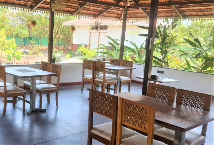 Airy wooden dining hall overlooking greenery at Tapasya Health & Wellness Ayurveda retreat