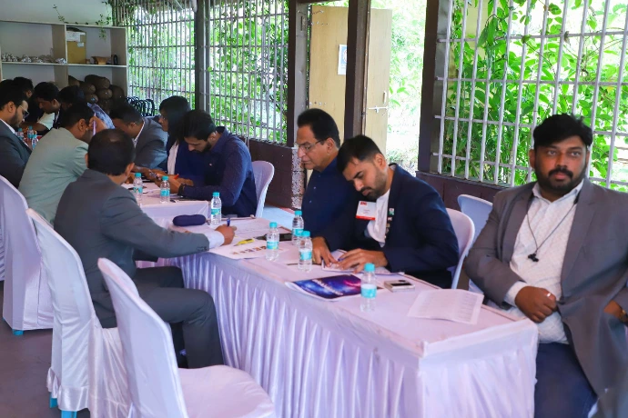 Business delegates at a corporate wellness session in the open pavilion at Tapasya Health & Wellness