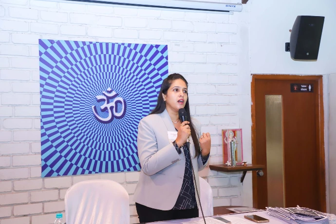 Speaker presenting an Ayurvedic wellness talk to attendees at Tapasya Health & Wellness