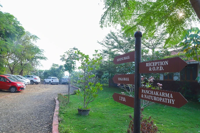 Reception and Panchakarma naturopathy signage at the Tapasya Health & Wellness campus entrance